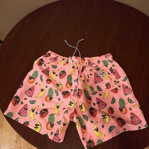 Brand new swim trunks. Pink with fruit prints.